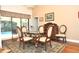 Formal dining room features classic decor, stylish chandelier, and a sliding glass door to lanai at 3189 Roxmere Dr, Palm Harbor, FL 34685