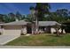Charming single-story home with a well-maintained lawn, mature trees and two-car garage at 3189 Roxmere Dr, Palm Harbor, FL 34685