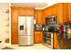Well-equipped kitchen boasts stainless steel appliances and ample wood cabinet storage at 3189 Roxmere Dr, Palm Harbor, FL 34685