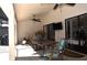 Spacious covered outdoor patio with ceiling fans, plenty of seating, and a wall-mounted television at 3189 Roxmere Dr, Palm Harbor, FL 34685