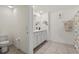 Bathroom with double vanity, updated fixtures, mirror, and beach themed shower curtain at 36541 Night Strawberry Ct, Dade City, FL 33525