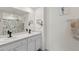 Bathroom with double vanity, updated fixtures, mirror, and beach themed shower curtain at 36541 Night Strawberry Ct, Dade City, FL 33525