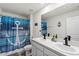 Bathroom featuring double sink vanity, nautical decor, toilet, and walk-in shower with blue anchor shower curtain at 36541 Night Strawberry Ct, Dade City, FL 33525