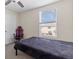Bedroom with ceiling fan, window with blinds, black bed, computer chair, and a white door at 36541 Night Strawberry Ct, Dade City, FL 33525