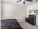 Bedroom with a ceiling fan, bed, a dresser with a TV on top, and nightstand at 36541 Night Strawberry Ct, Dade City, FL 33525