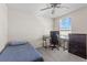 Bedroom featuring a twin bed, ceiling fan, and a desk and chair for study or gaming at 36541 Night Strawberry Ct, Dade City, FL 33525