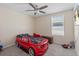 bedroom featuring a car-shaped bed, a ceiling fan, and natural light from the window at 36541 Night Strawberry Ct, Dade City, FL 33525