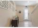 Warm entryway with tile flooring, console table, and decorative wall art at 36541 Night Strawberry Ct, Dade City, FL 33525
