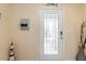 Inviting entryway featuring a glass paneled door and coastal decor at 36541 Night Strawberry Ct, Dade City, FL 33525
