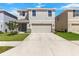 Charming two-story home with a well-maintained lawn, stone accents, and attached two-car garage at 36541 Night Strawberry Ct, Dade City, FL 33525