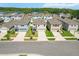 Aerial view of a neighborhood with homes near a lake and lush greenery at 36541 Night Strawberry Ct, Dade City, FL 33525