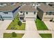 Exterior elevation of a modern two-story home with a two-car garage and well-manicured lawn at 36541 Night Strawberry Ct, Dade City, FL 33525