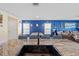 Modern kitchen featuring granite countertops, an island sink, and an open floor plan into the dining area at 36541 Night Strawberry Ct, Dade City, FL 33525