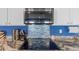 Kitchen closeup featuring updated countertops, backsplash, and stainless appliances at 36541 Night Strawberry Ct, Dade City, FL 33525