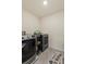 Laundry room with new washer and dryer and organized storage and a laundry room mat at 36541 Night Strawberry Ct, Dade City, FL 33525