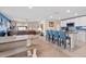 Open floor plan with kitchen island, living area, and dining table at 36541 Night Strawberry Ct, Dade City, FL 33525