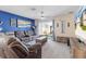 Comfortable living room with plush seating, neutral carpet, and sliding glass doors to the backyard at 36541 Night Strawberry Ct, Dade City, FL 33525