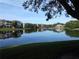 Scenic view of a tranquil pond reflecting the surrounding buildings and lush trees at 4107 Chatham Oak Ct # 326, Tampa, FL 33624
