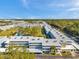 Expansive aerial view of an apartment complex featuring a pool and lush landscaping at 4720 Locust Ne St # 206, St Petersburg, FL 33703