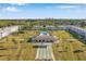 Aerial scene showcasing residences, community pool, shuffleboard, and green spaces amid a vibrant neighborhood setting at 4720 Locust Ne St # 206, St Petersburg, FL 33703
