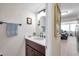 Nicely decorated half bathroom featuring a vanity with a vessel sink and dark wood cabinets at 4720 Locust Ne St # 206, St Petersburg, FL 33703