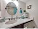 This bathroom has white countertop and ample vanity space. The round mirror gives the room elegance at 4720 Locust Ne St # 206, St Petersburg, FL 33703