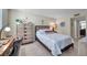 This is a beautifully staged bedroom featuring warm paint and natural wood furniture accents at 4720 Locust Ne St # 206, St Petersburg, FL 33703