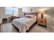 This bed is neatly made with white patterned linens and the bedroom is clean and organized at 4720 Locust Ne St # 206, St Petersburg, FL 33703