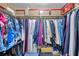 Organized walk-in closet with clothes hanging on rods, and storage on the upper shelf at 4720 Locust Ne St # 206, St Petersburg, FL 33703