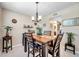 Dining room with modern table set, chandelier, and plants offering an inviting atmosphere for meals at 4720 Locust Ne St # 206, St Petersburg, FL 33703
