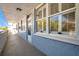 Hallway featuring unit 206 with a full-length window and textured walls, providing access to outdoor space at 4720 Locust Ne St # 206, St Petersburg, FL 33703