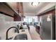 Modern kitchen offering stainless steel appliances and opening to a living room with ample natural light at 4720 Locust Ne St # 206, St Petersburg, FL 33703