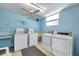 On-site laundry room with washers, dryers, sink, ceiling fan and window at 4720 Locust Ne St # 206, St Petersburg, FL 33703