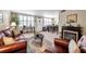 Cozy living room featuring hardwood floors, a fireplace, leather furniture, and plantation shutters at 4720 Locust Ne St # 206, St Petersburg, FL 33703