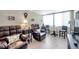 This living room has wood look floors, lots of windows, and two oversized leather recliners at 4720 Locust Ne St # 206, St Petersburg, FL 33703