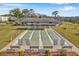 Community shuffleboard court with benches, framed by lush landscaping, offering a recreational space for residents at 4720 Locust Ne St # 206, St Petersburg, FL 33703