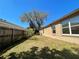 View of a backyard with green grass and a wood fence, offering a private and spacious outdoor setting at 4731 Portobello Cir, Valrico, FL 33596