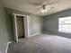 A bedroom with gray walls, carpet, a ceiling fan, and a window with blinds at 4731 Portobello Cir, Valrico, FL 33596