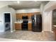 A modern kitchen featuring stainless steel appliances, wood cabinets and new vinyl flooring at 4731 Portobello Cir, Valrico, FL 33596