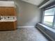 An eat-in kitchen nook features a window, wood cabinets, and a gray tile floor at 4731 Portobello Cir, Valrico, FL 33596