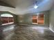 A spacious living room features two windows with wood blinds and sleek, light laminate flooring at 4731 Portobello Cir, Valrico, FL 33596