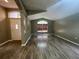 A bright living room featuring light gray walls, a large window, and wood laminate flooring at 4731 Portobello Cir, Valrico, FL 33596
