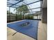 A screened-in pool with a blue cover surrounded by lush greenery and a privacy fence at 4731 Portobello Cir, Valrico, FL 33596