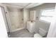 Well-lit bathroom featuring a shower stall, vanity, mirror, and toilet at 4851 W Gandy Blvd # B2L11, Tampa, FL 33611