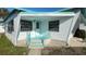 Close up of the front of the home with the steps up to the white front door and teal railings at 4851 W Gandy Blvd # B2L11, Tampa, FL 33611