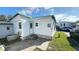 Charming home featuring a white exterior, turquoise trim, and tidy landscaping at 4851 W Gandy Blvd # B2L11, Tampa, FL 33611