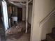 Unfinished basement with exposed pipes, stairs, and a utility sink area needing renovations at 613 Chestnut St, Oldsmar, FL 34677