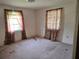 Bedroom featuring natural light from two windows, and basic electrics, but in need of repair at 613 Chestnut St, Oldsmar, FL 34677