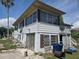 Exterior elevation view of the two-story home, showing the backyard, and requiring repair and renovation at 613 Chestnut St, Oldsmar, FL 34677