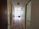 Hallway with carpeted floor, neutral walls, and several doors leading to other rooms at 613 Chestnut St, Oldsmar, FL 34677